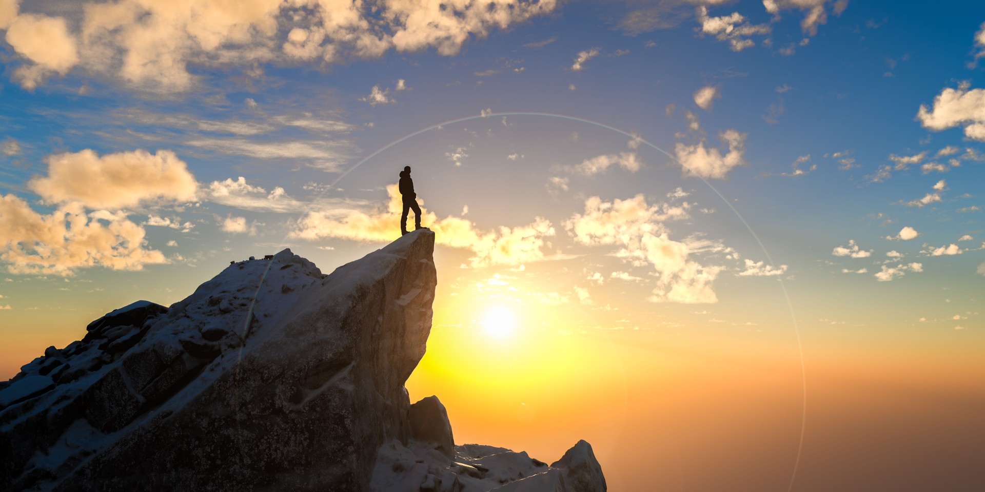 Person standing on mountain top at sunrise looking at sky symbolizing success motivation ambition adventure inspiration achievement, leadership solitude dream altitude